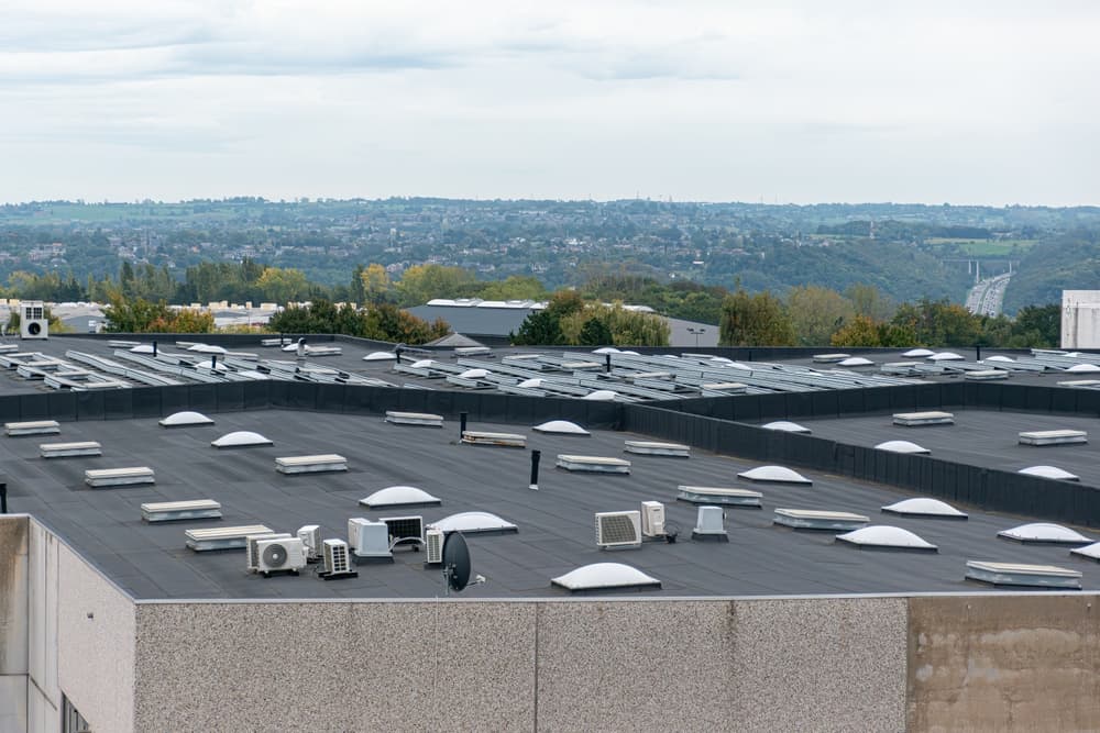 Large commercial flat roof with rooflights and ventilation equipment