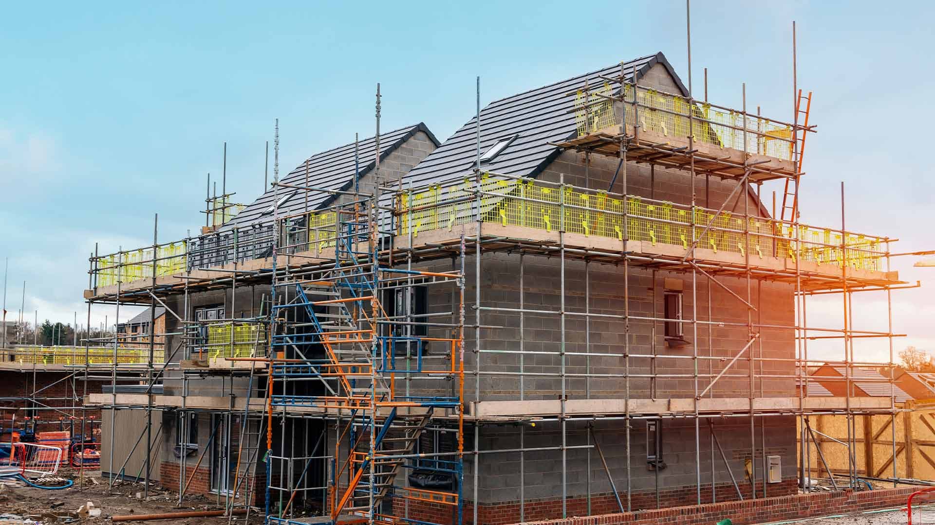 Pitched roof and dormers surrounded by scaffolding