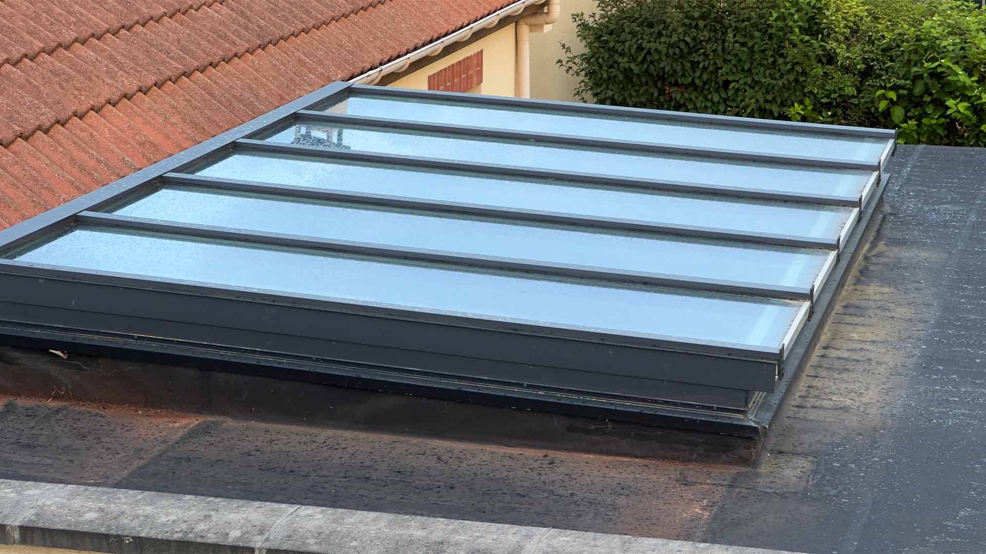 Glazed rooflight with dark metal frames installed in a flat roof