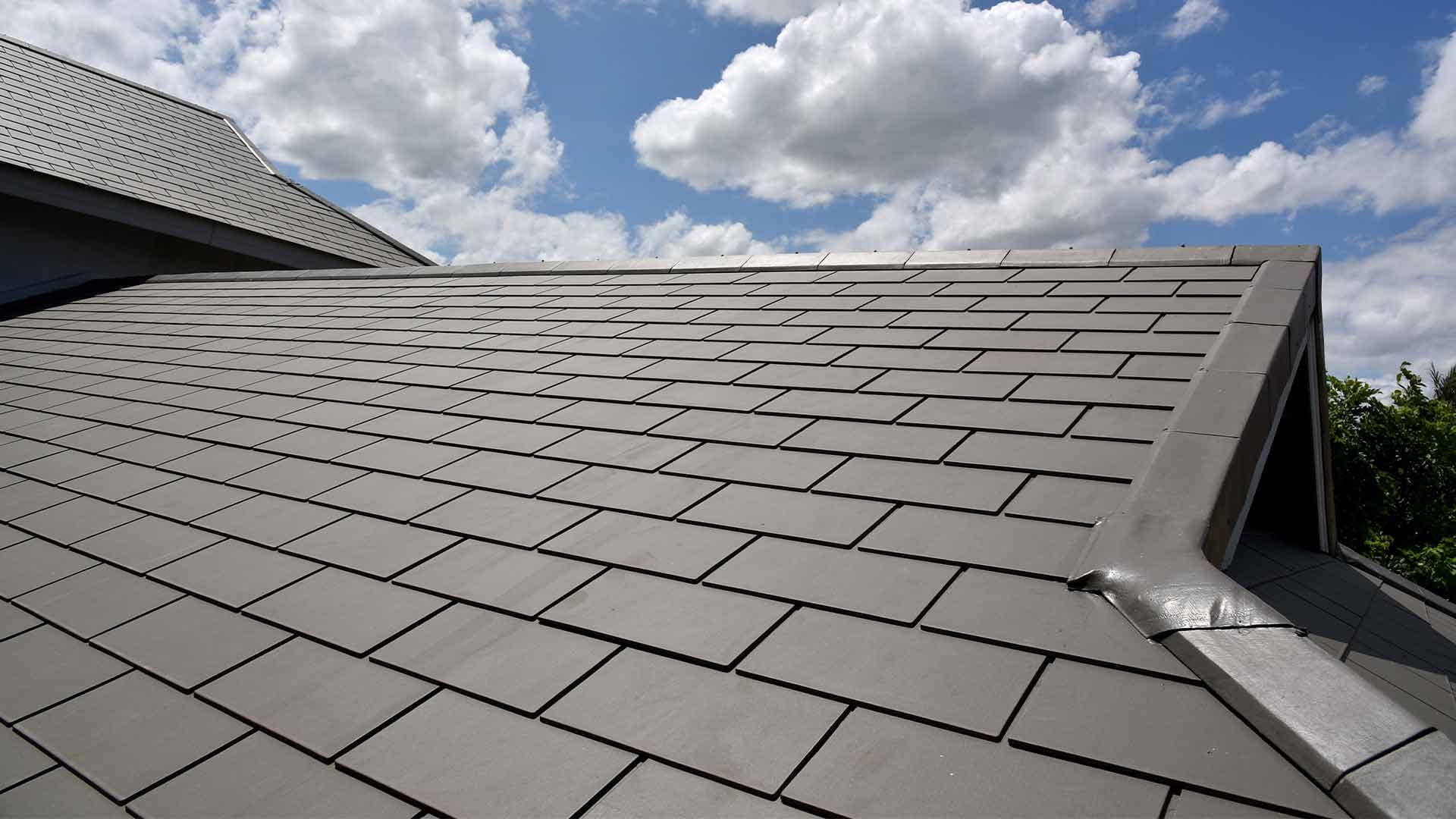 Slate roof with neatly finished tiles and ridge detailing